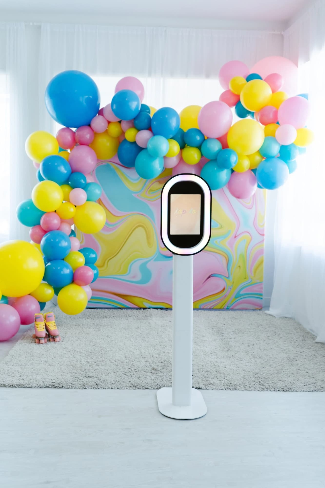Photo booth with a balloon garland backdrop