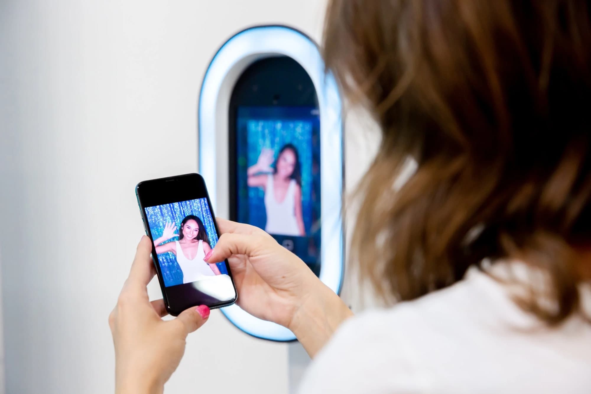 A guest sharing a photo booth capture from her phone