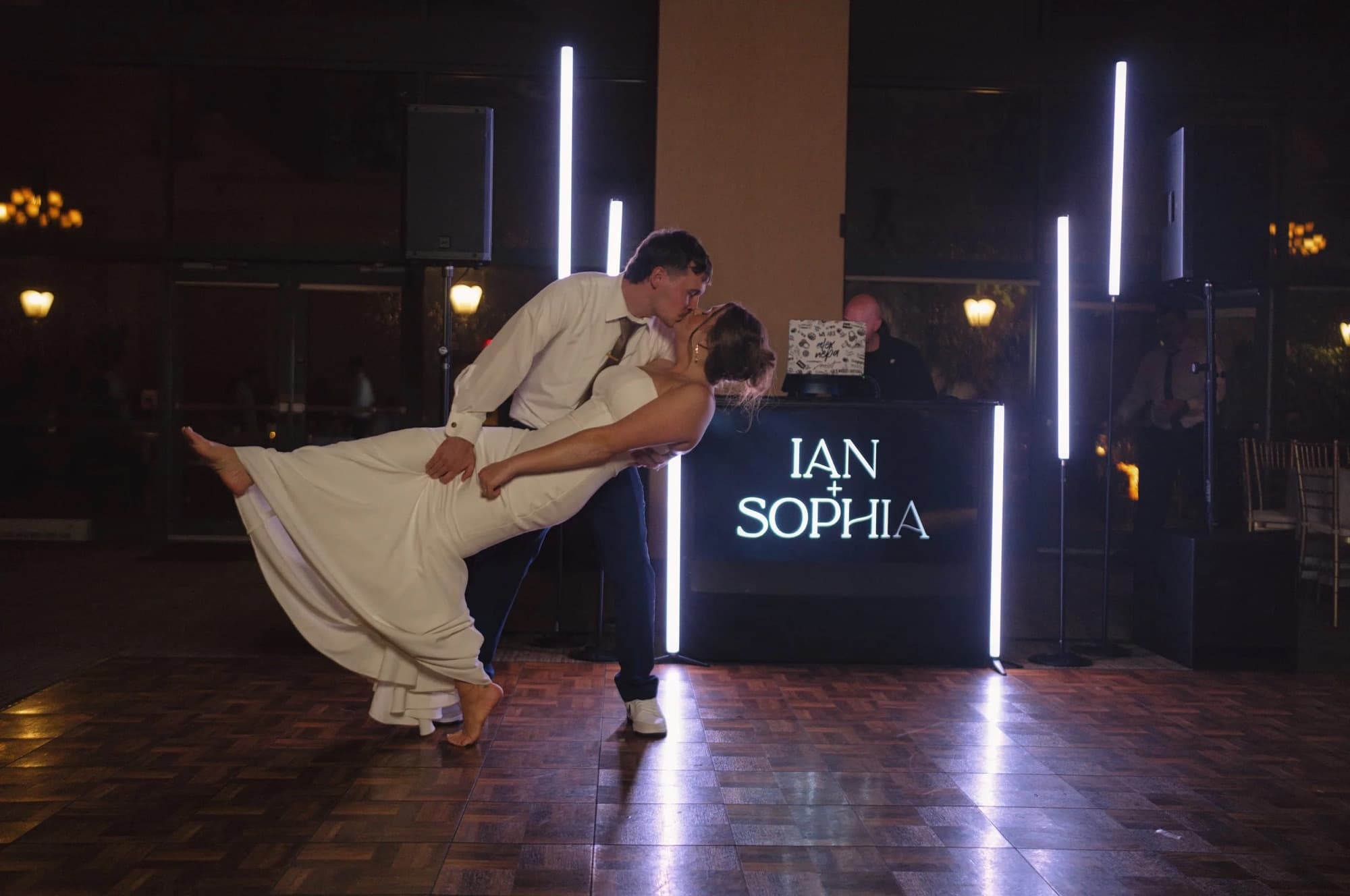 First dance dip under a custom monogram