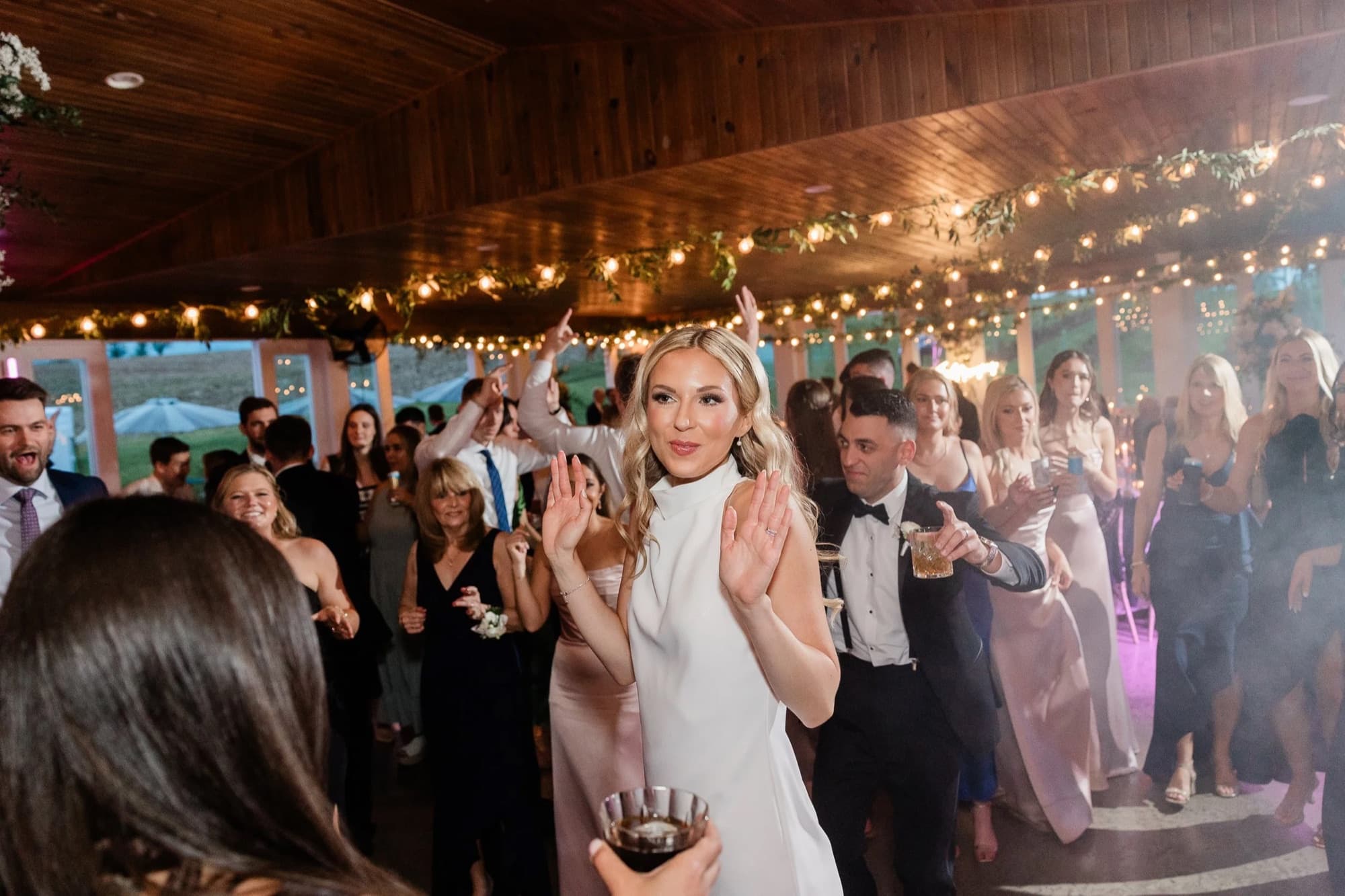 Guests dancing under string lights
