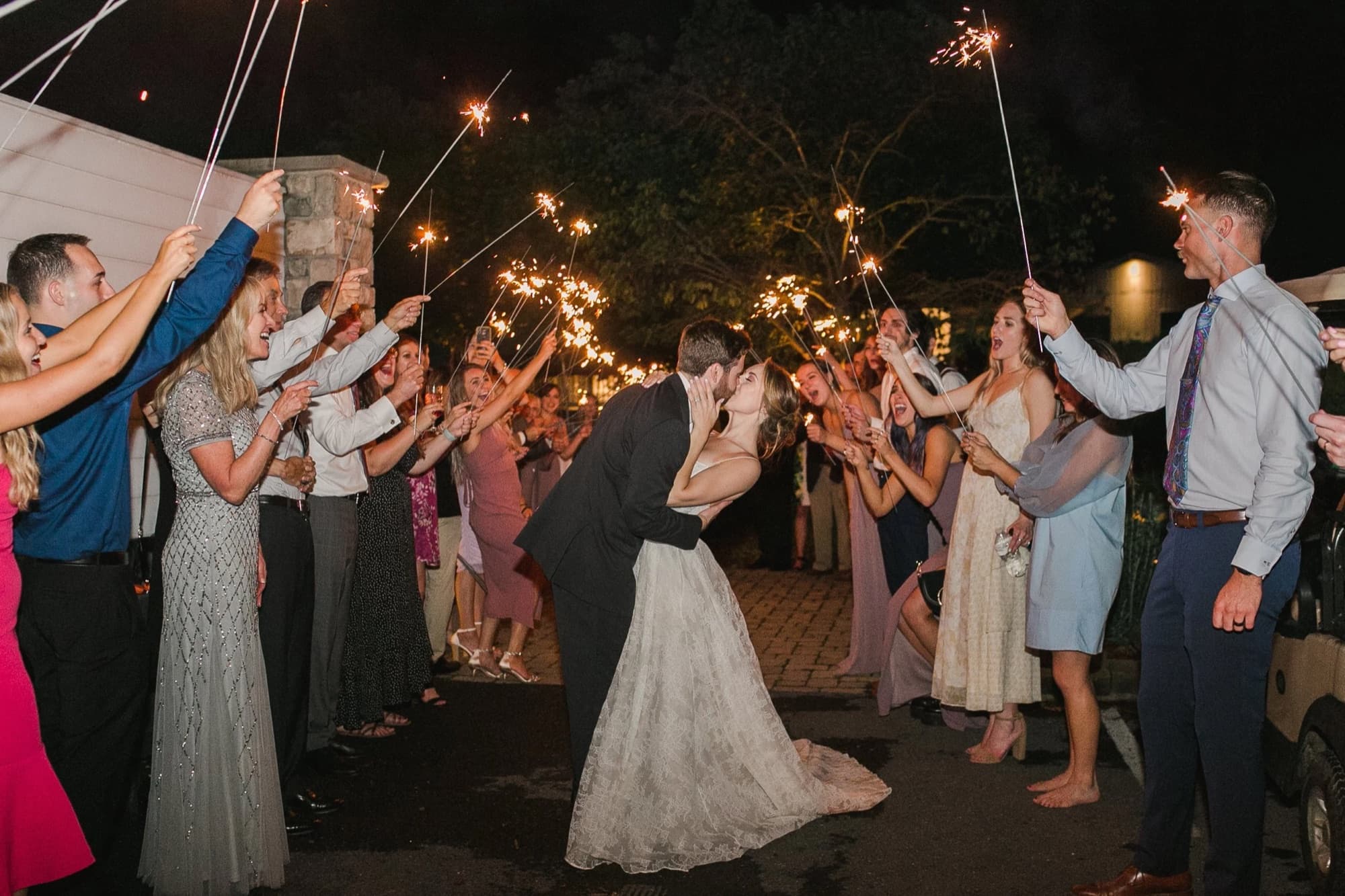 Couple leaving their reception through a sparkler tunnel