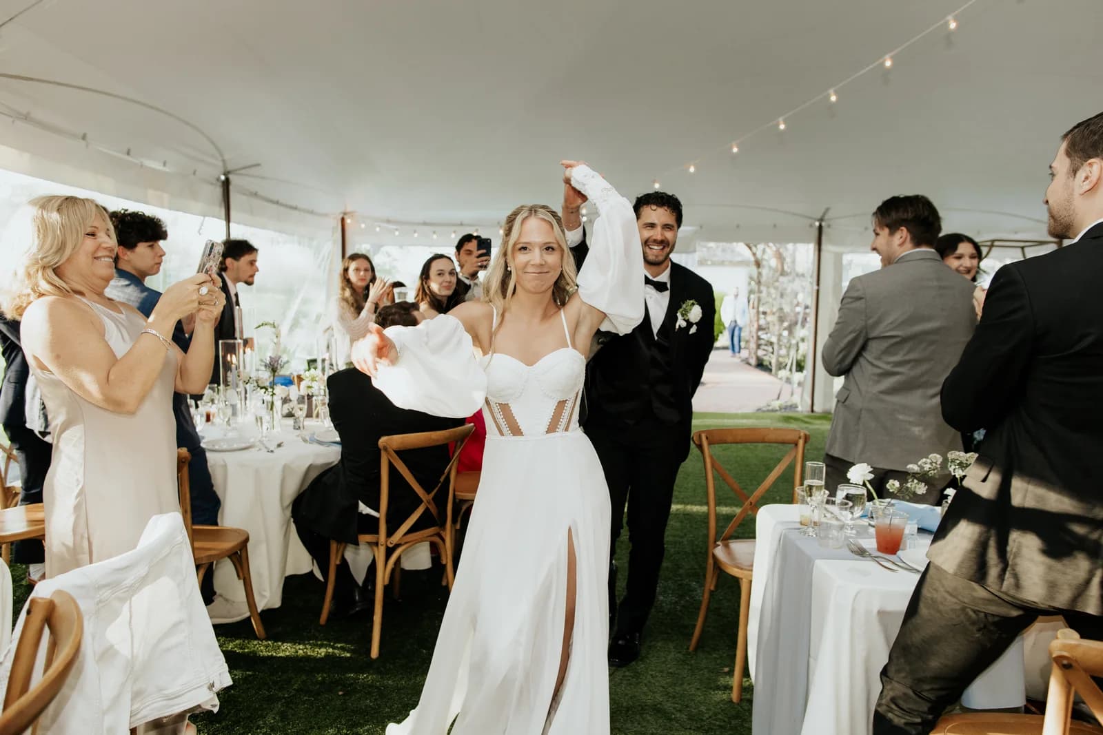 Newlyweds entering their tent reception at Cypress House