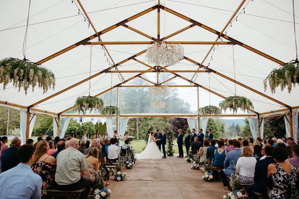 Wedding ceremony beneath the bright pavilion at Herman and Luthers
