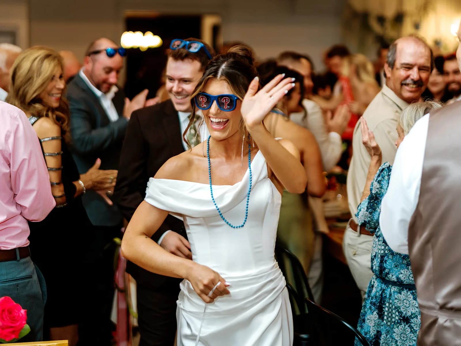 Bride in blue sunglasses celebrating with guests at Pocono Pines